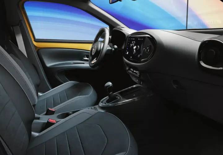 Wnętrze samochodu z nowoczesnymi fotelami i ekranem dotykowym. System keyless go ułatwia wsiadanie i ruszanie.
