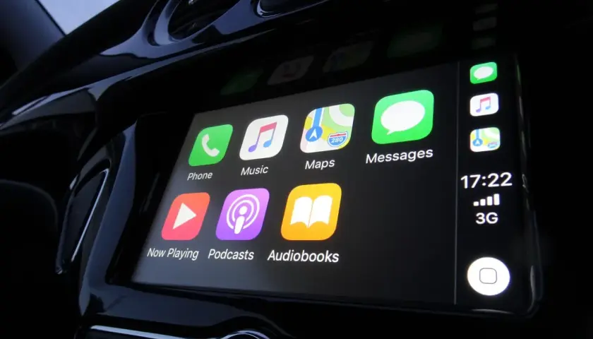 Ekran samochodu z ikonami: Telefon, Muzyka, Mapy, Wiadomości, Odtwarzanie, Podcasty, Audiobooki. To jest właśnie co to jest CarPlay.