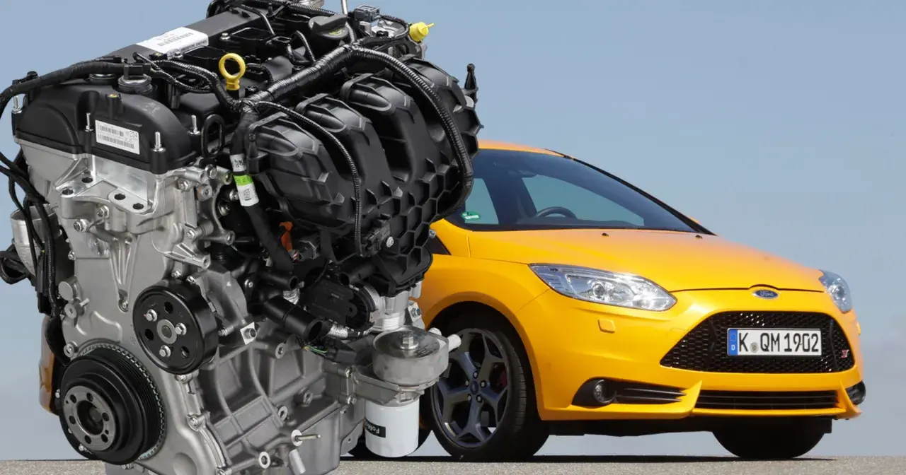 Silnik 2.0 Ecoboost obok żółtego Forda Focus ST. Potężna jednostka napędowa, serce sportowego samochodu.